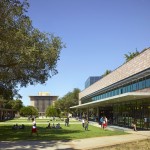 Students walk on the Harvey Mudd College campus near the Shanahan Center with Sprague Center in the background