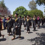 grads in caps and gowns walking