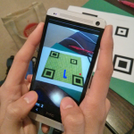 Close-up of hands holding device showing app.