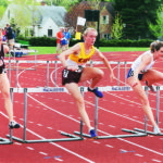 Track and field alumna Katie Ray, Class of 2002, jumps hurdles for CMS