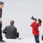 Young boy takes photo of parent at Harvey Mudd event