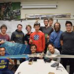 Student and faculty team and airplane pieces