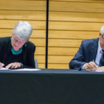 Maria Klawe signing paper