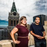 Edith Harbaugh and John Kodumal atop a tall building