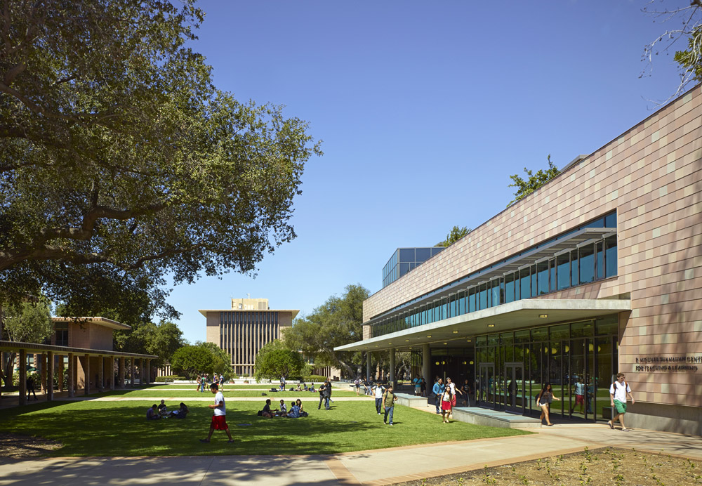 Students walk on the Harvey Mudd College campus near the Shanahan Center with Sprague Center in the background