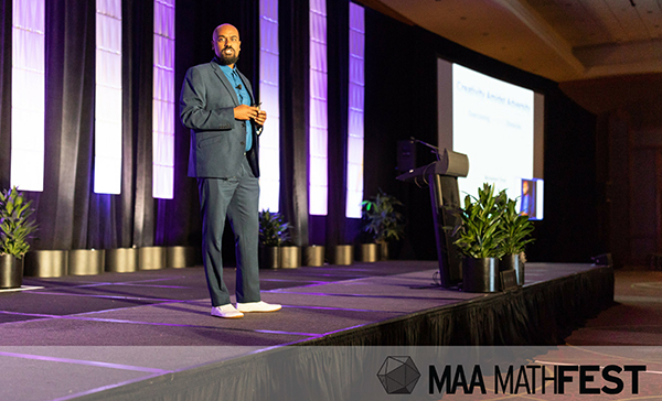 Harvey Mudd math professor Mohamed Omar delivering address at 2018 MathFest. Photo courtesy of Mathematical Association of America.
