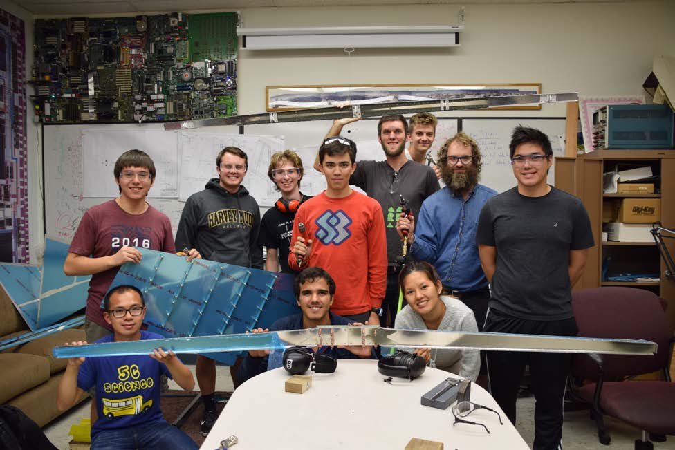 Student and faculty team and airplane pieces