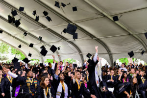 Graduates throwing caps in air