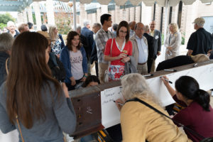 Guests sign a construction beam.