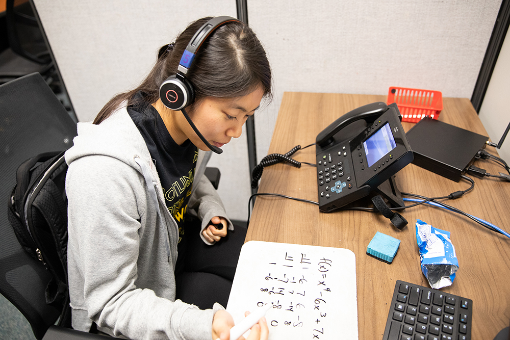 Student speaking doing math while on the phone