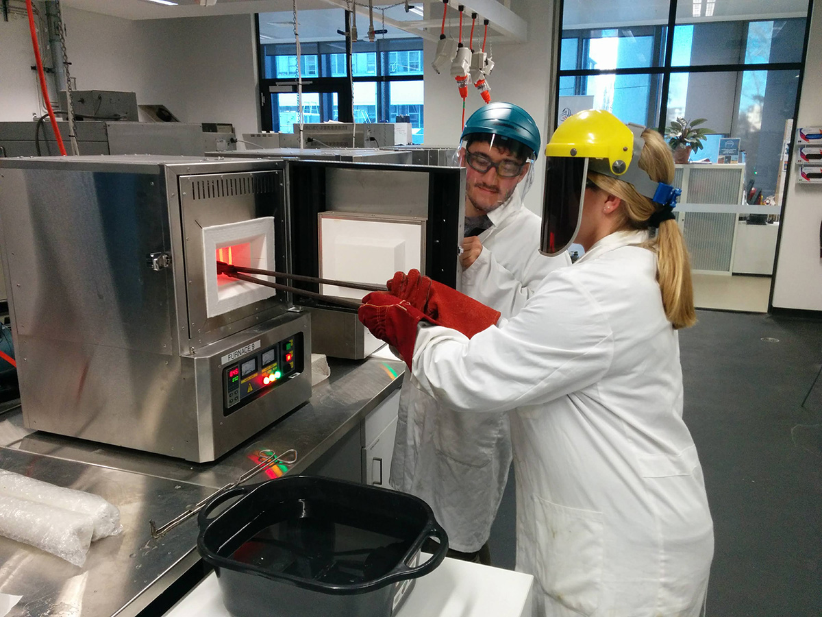 students pulling samples from a furnace