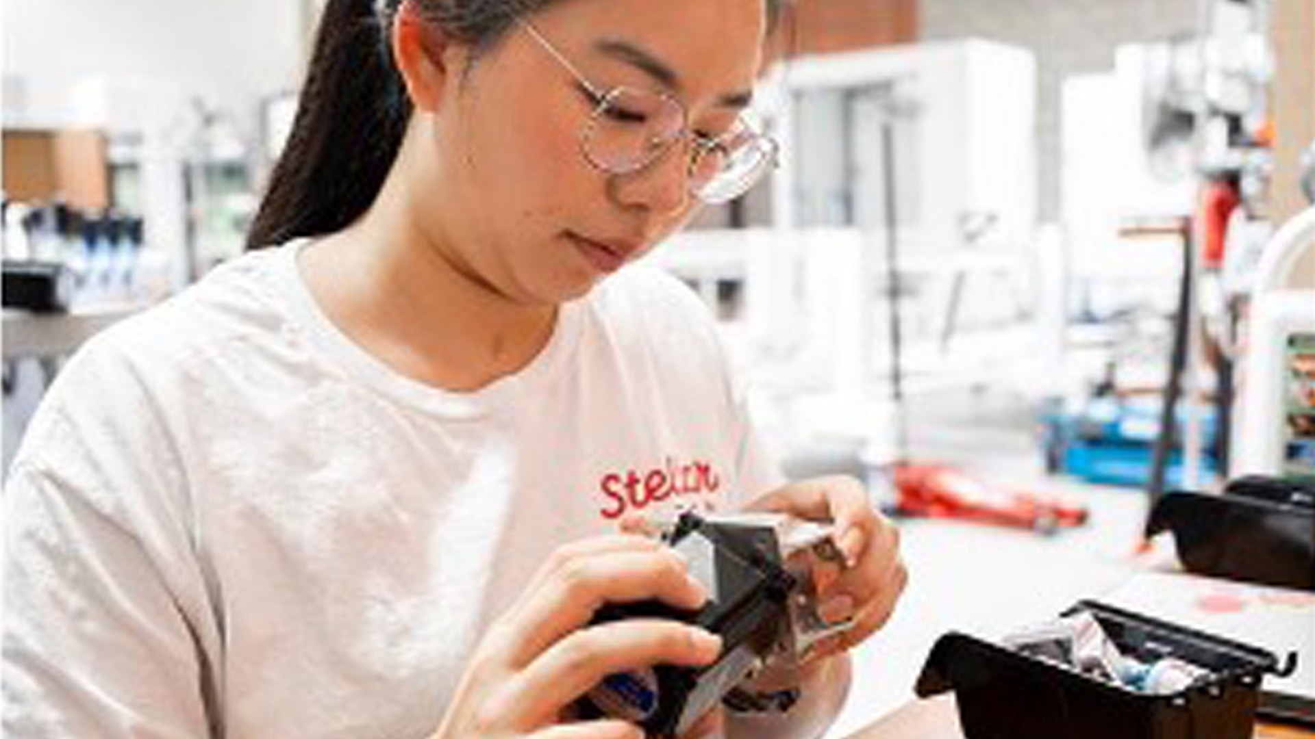 Jenny Wathanakulchat works on a gadget at Stellar Pizza.-1920