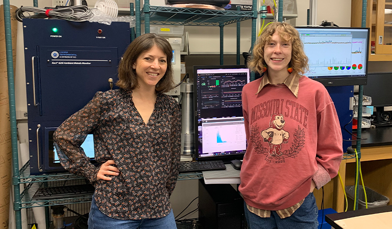 Lelia Hawkins and Eleanor Bentley standing in front of climate research equipment.