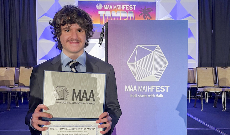 Daniel Vargas poses with his Merten M. Hasse Prize certificate at the 2023 MAA MathFest.
