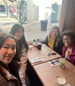 Cynthia Martinez and students seated at a restaurant.
