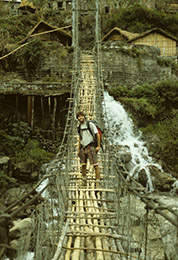 Harvey Mudd Watson Fellow Alan Baron on a suspension bridge in Nepal