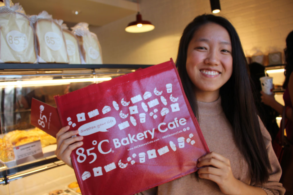 Cathy posing with a bag from the new 85 degrees bakery in Claremont