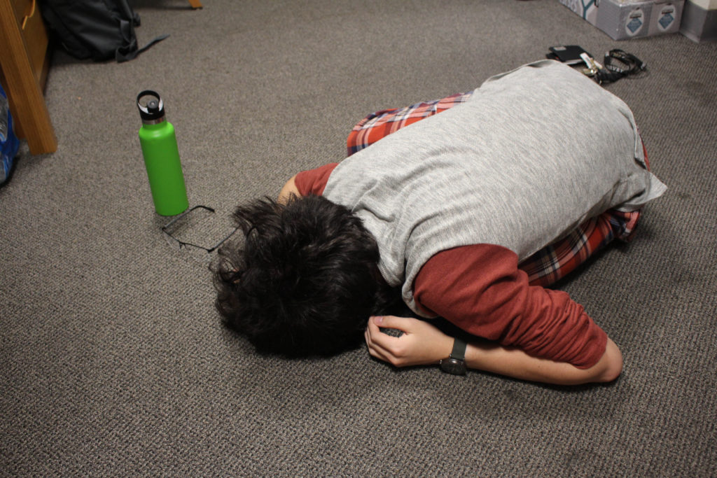 Forest taking a little break on a dorm room floor after finishing a math problem set.