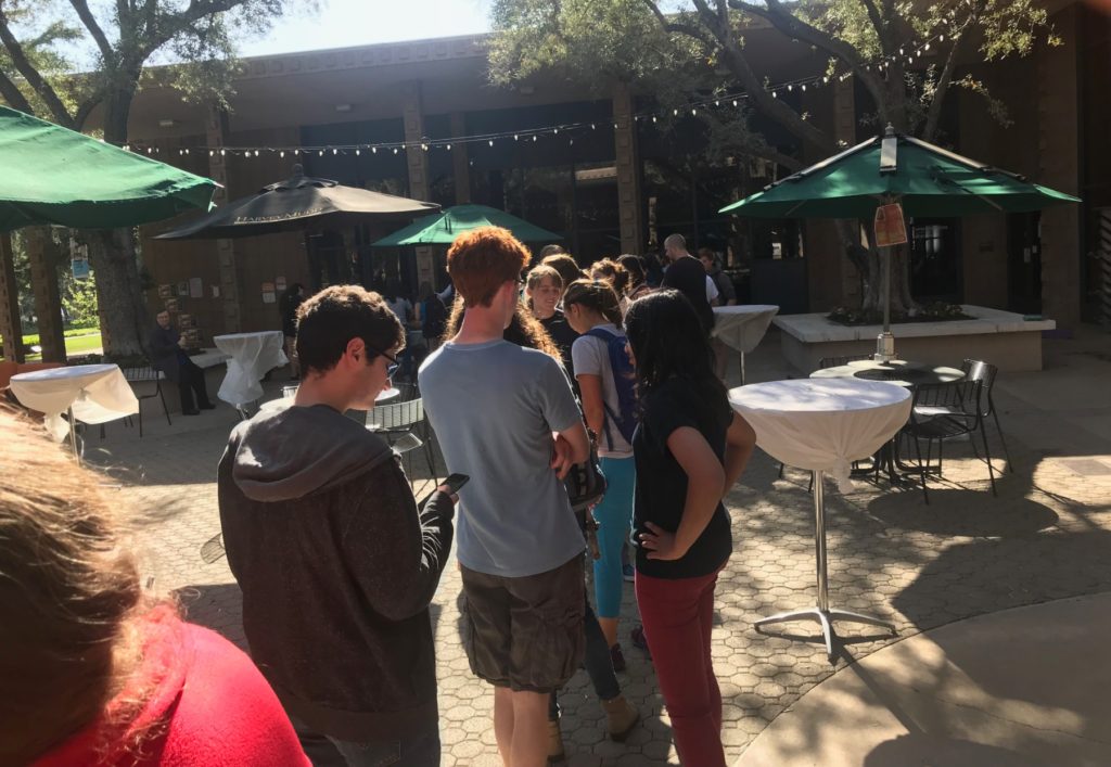 A line of students leading to a refreshments table.