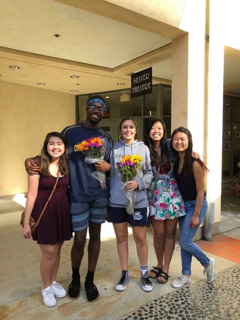 students pose outside the theatre 