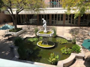 Hixon Court fountain as seen from above. There is a statue of Venus in a large fountain with lilypads and koi fish