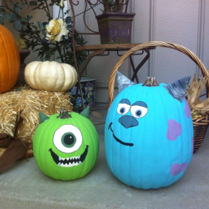 The picture features two pumpkins painted to look like monsters.