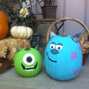 The picture features two pumpkins painted to look like monsters. 