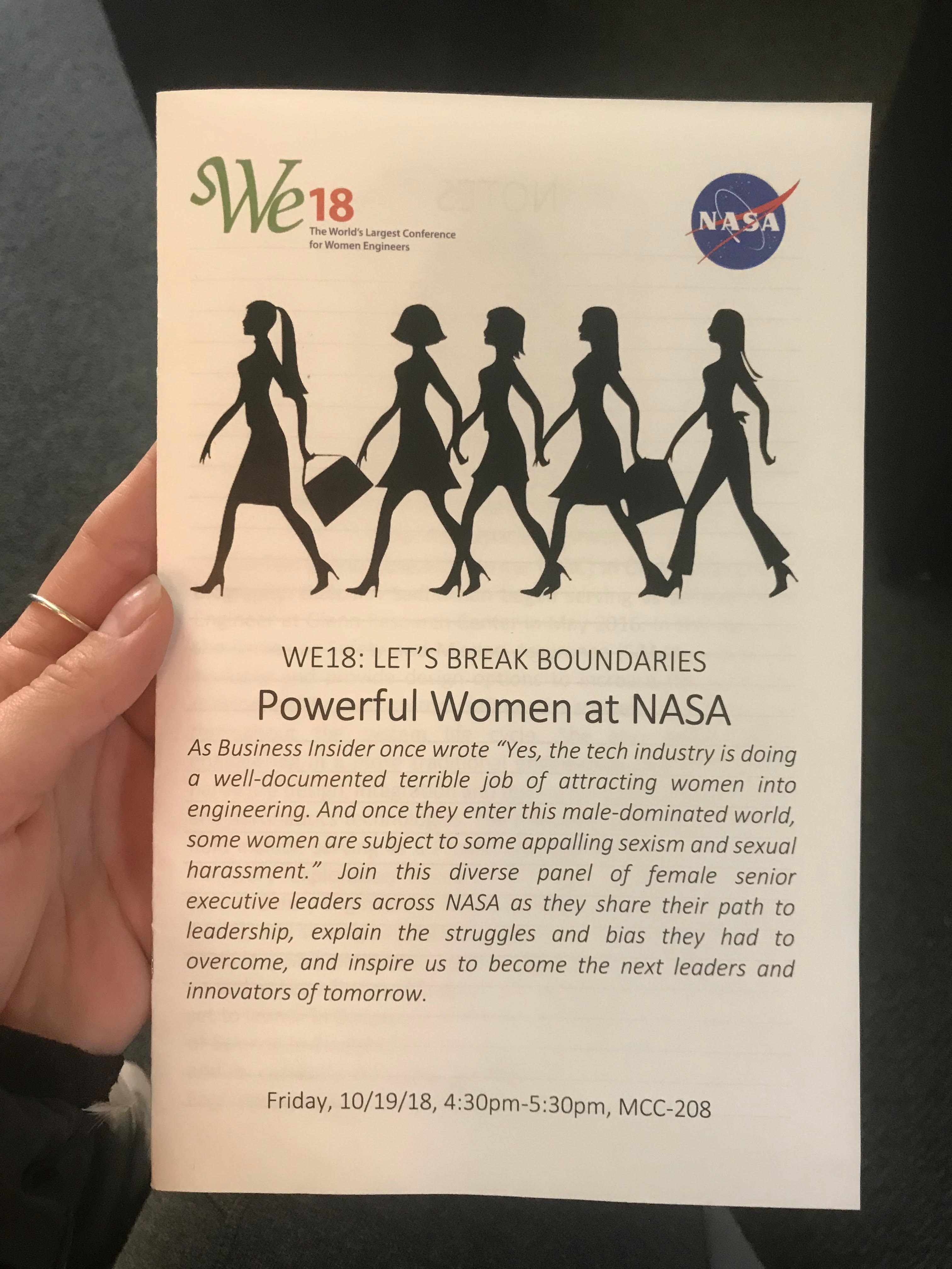 A photo of a pamphlet that reads: "WE18: LET'S BREAK BOUNDARIES. Powerful Women at NASA" with a further description of the talk below.