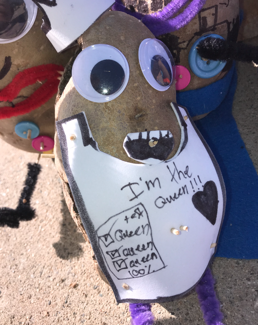 A queen potato with googly eyes has a crown to confirm that she is the queen