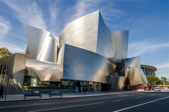 The exterior of the Walt Disney Opera House is shiny and silver. The building has interesting block shapes with curves and sharp corners