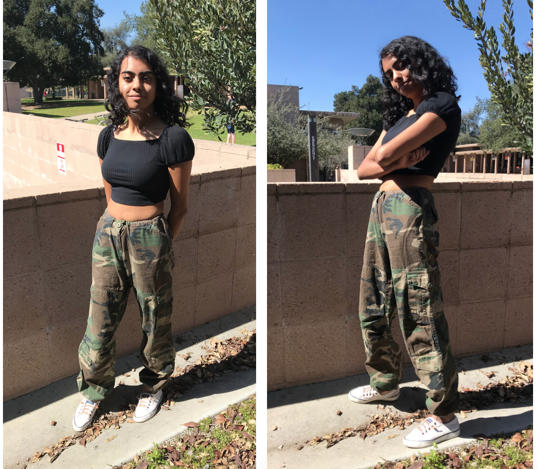 Neeta is wearing camo cargo pants that used to belong to Rico Nasty. She is also wearing a black crop top that has short sleeves.
