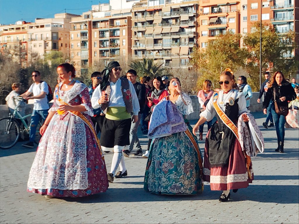 women and men in Spanish costumes walking