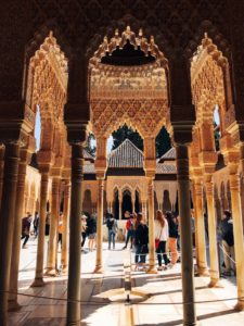 a view of a courtyard and Islamic columns from the inside
