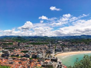 a view of a city, mountains, and a beach