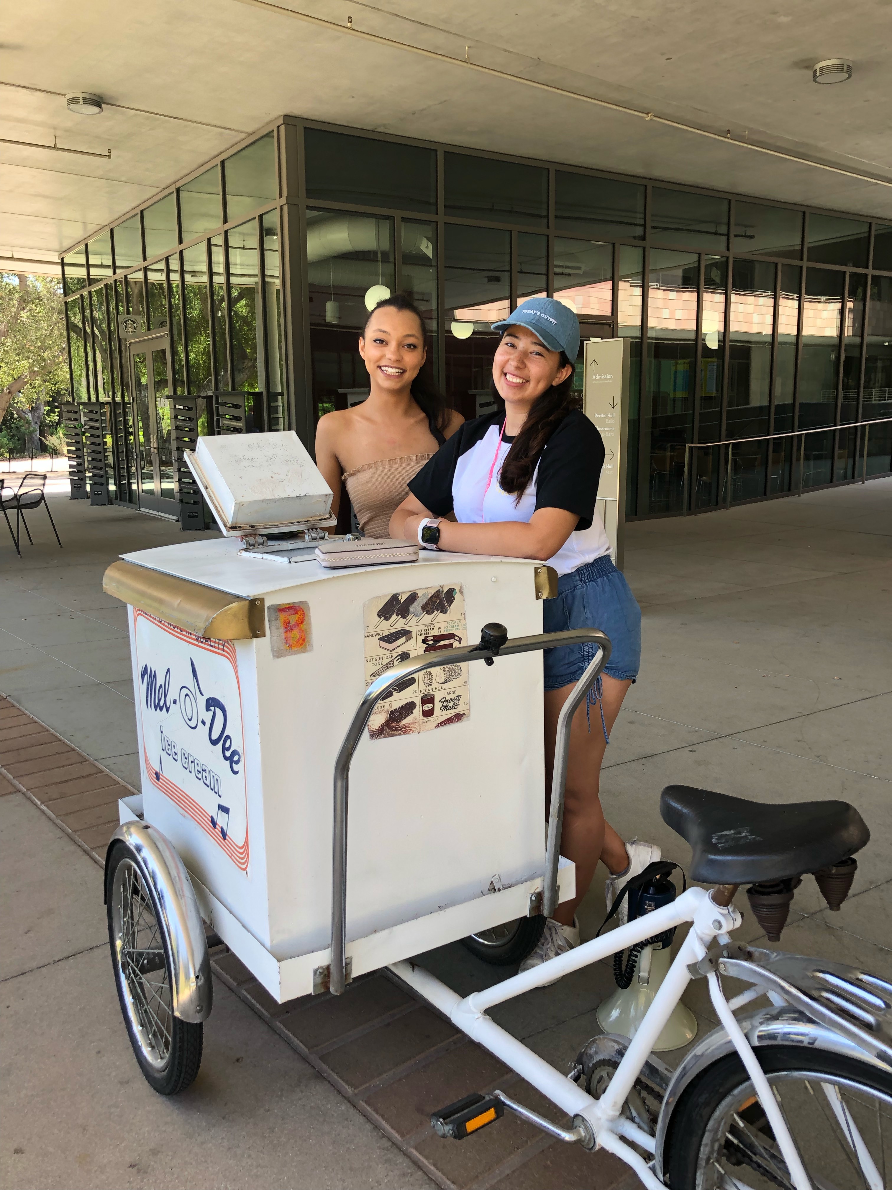 Lorelei and Toty selling ice cream in front of the R. Michael Shanahan Teaching Center