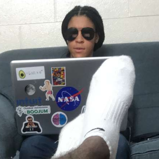 Savanna Beans wearing sunglasses, working on her laptop, studying at 2 AM in the morning