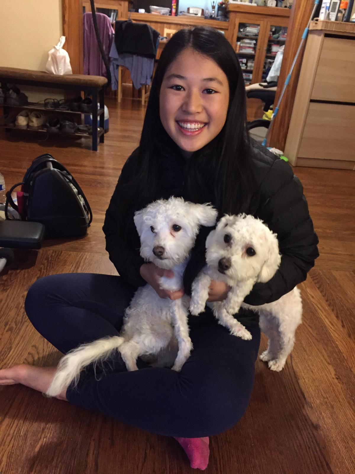 Kailee Lin holding two fluffy white dogs!