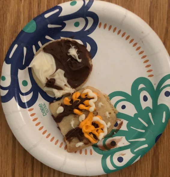 A plate with two cookies on it.