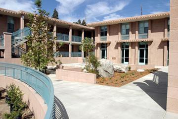 Courtyard area with outdoor staircases and trees.