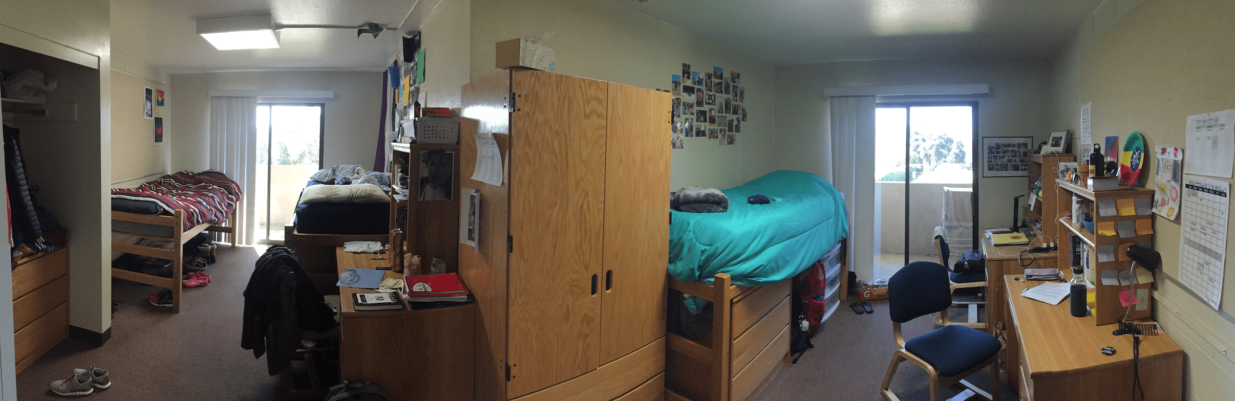 Image of a college dorm room with beds, dressers, and desks.