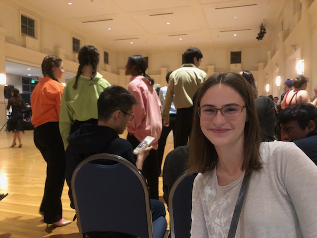 Hannah in front of a group of dancers