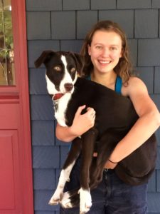 woman holding a large dog