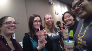 Sol, Hannah, and their group of mentees each hold a cup of bubble tea