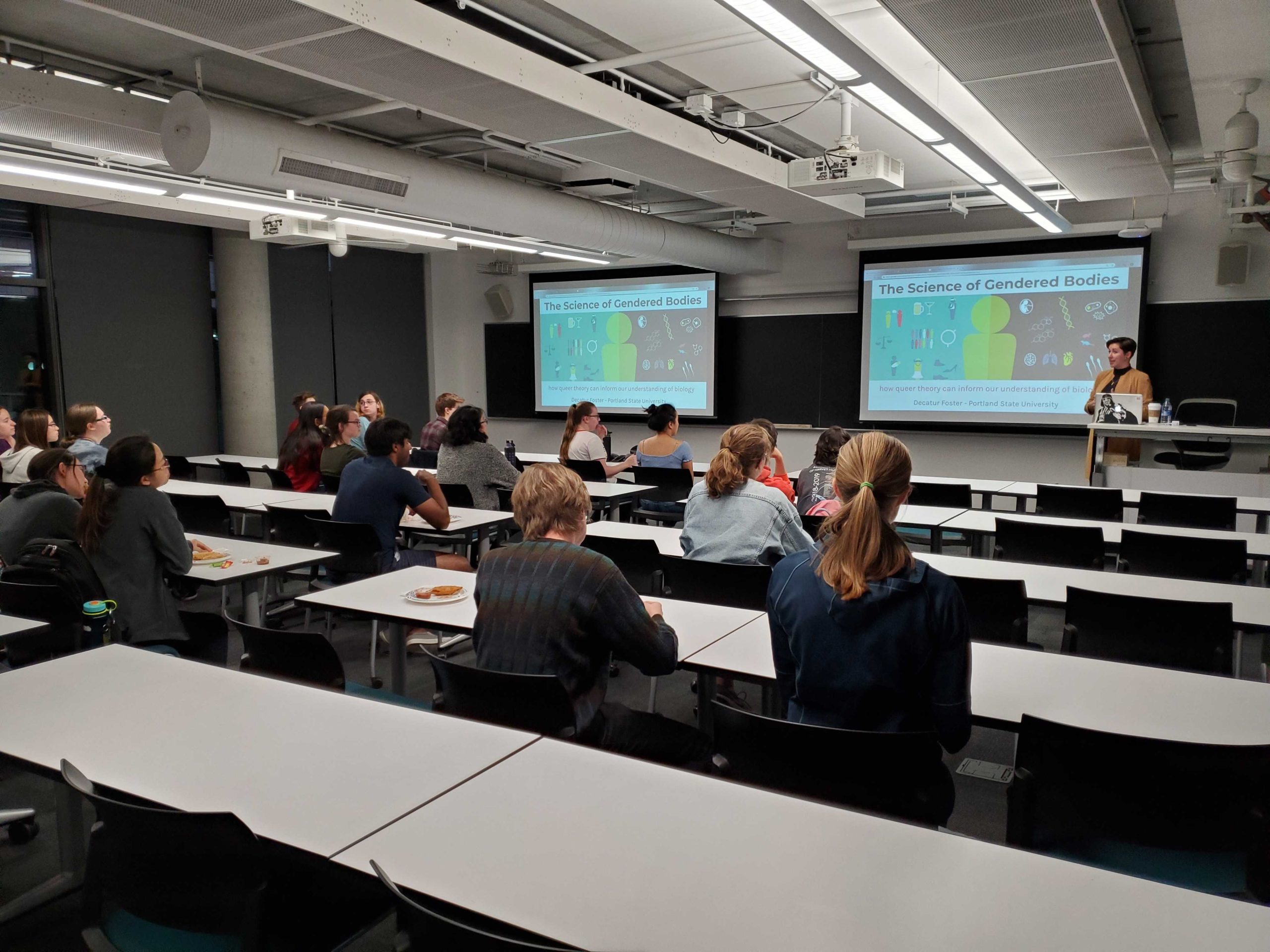 Students sit in a classroom watching a presentation.