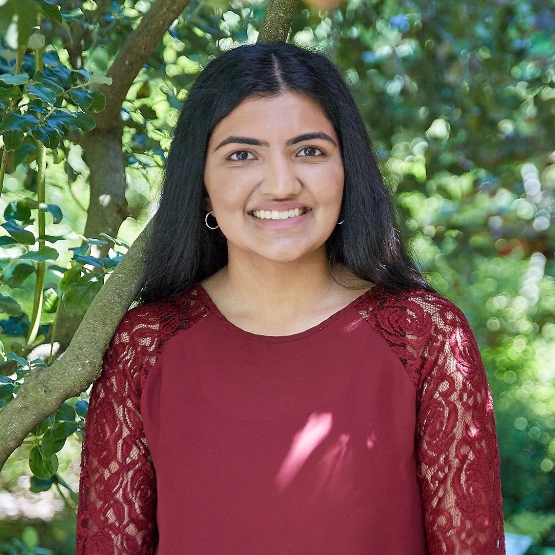 A headshot of Shifa in front of a tree.