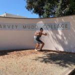 Melis posing with the HMC sign