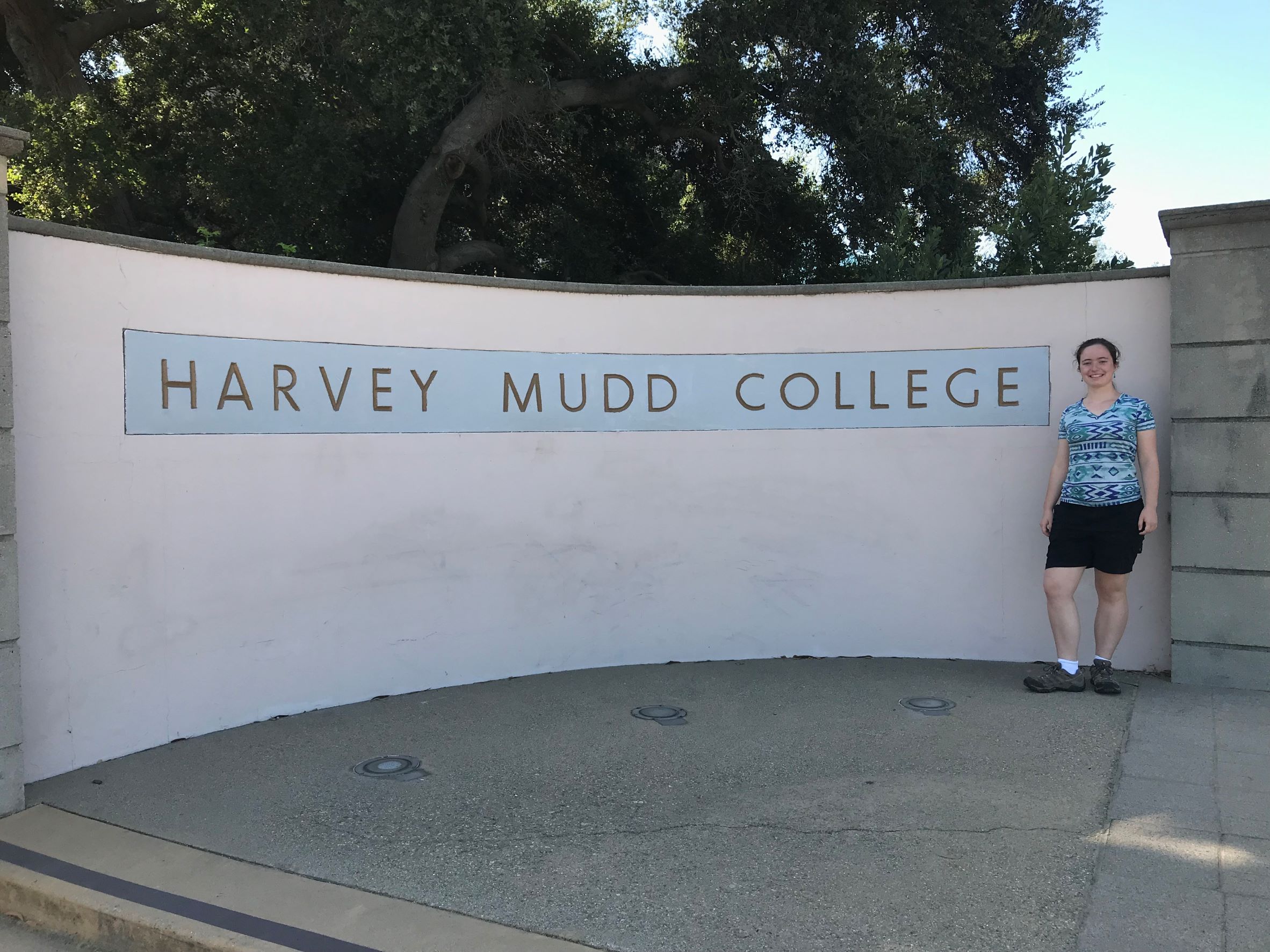 Malia standing by a large sign reading "Harvey Mudd College"