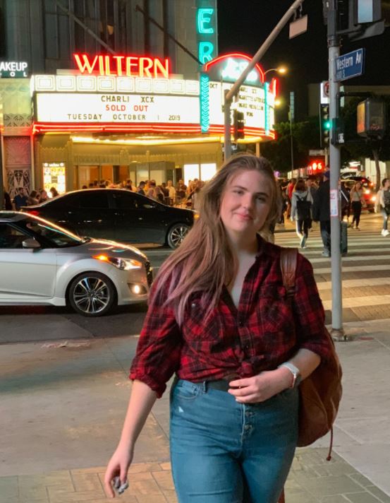 Elise stands in front of a concert venue in LA