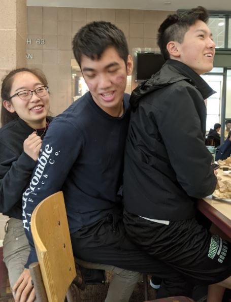 Two Mudd students sitting on each other on a chair