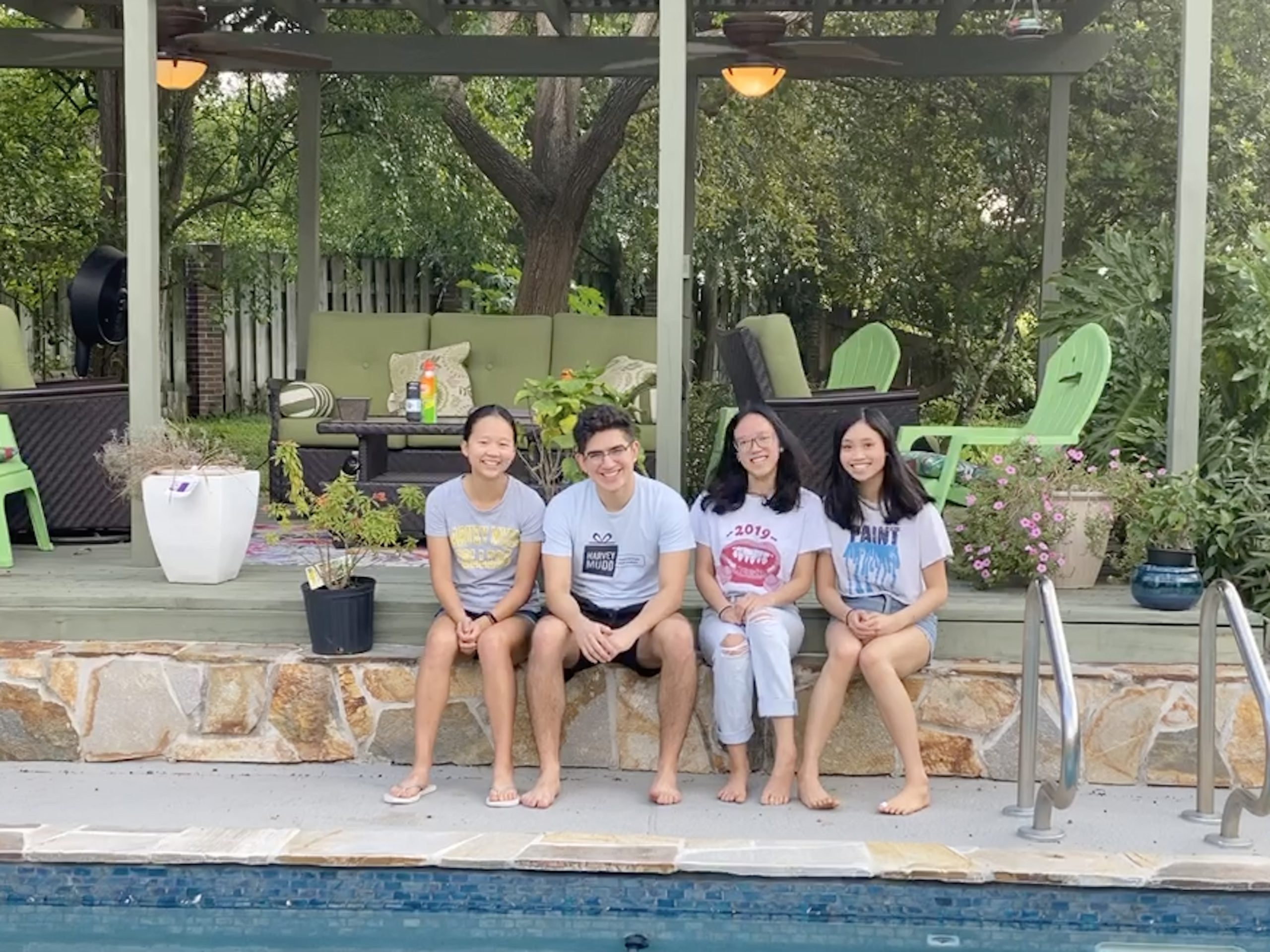 Four students sitting together on a bench